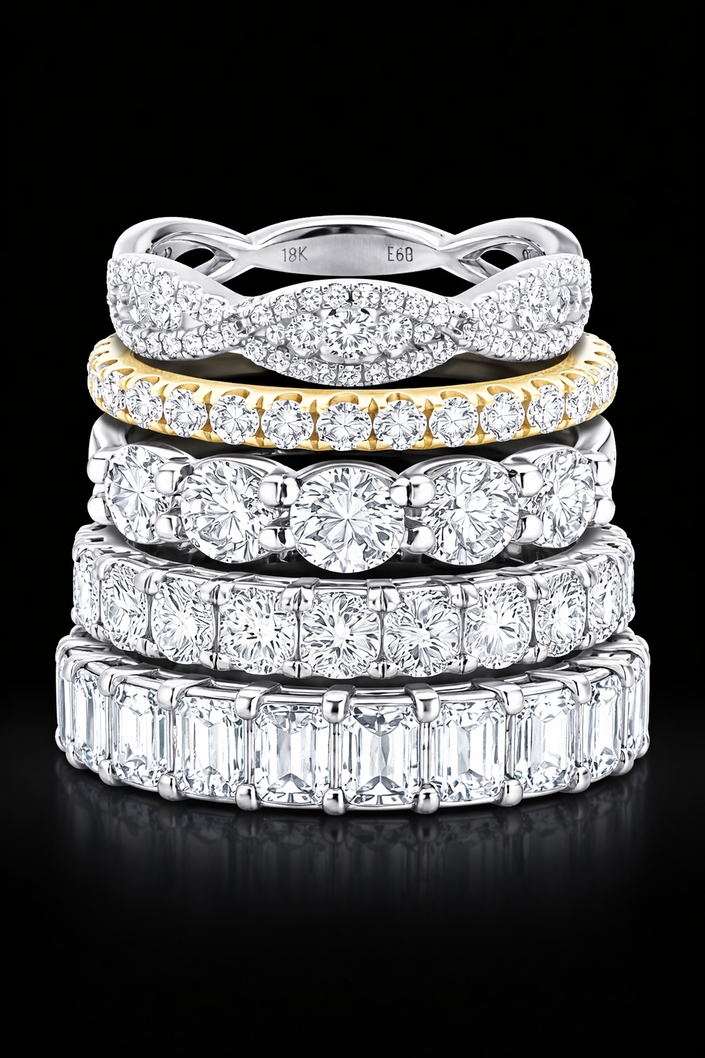 Stack of diamond wedding band rings on a black background